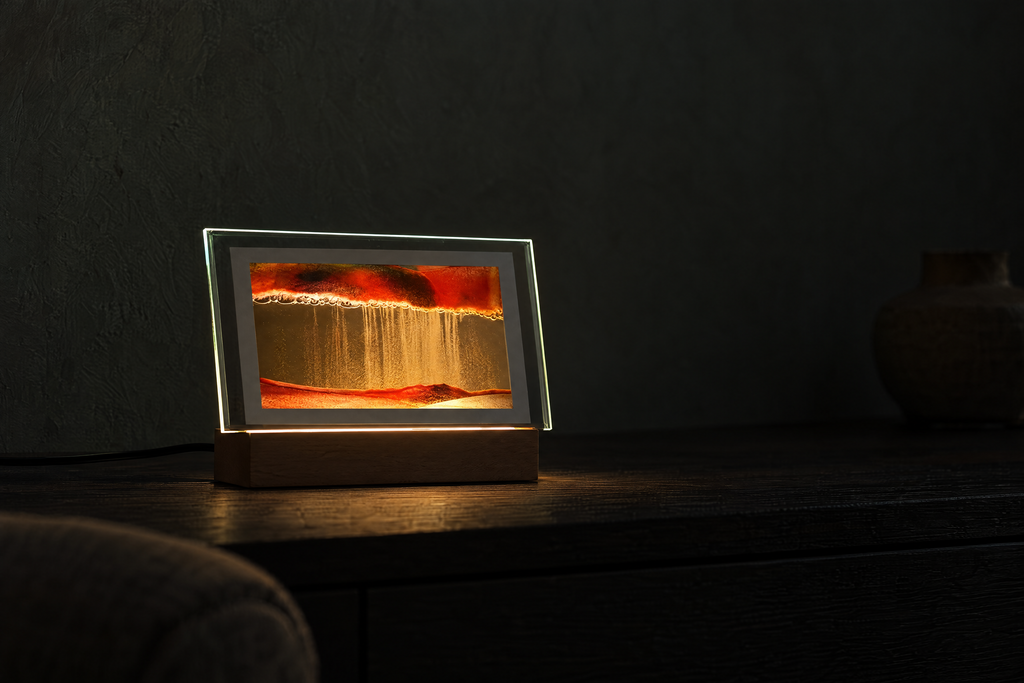 Burnt orange sand art displayed horizontally on a dark sideboard
