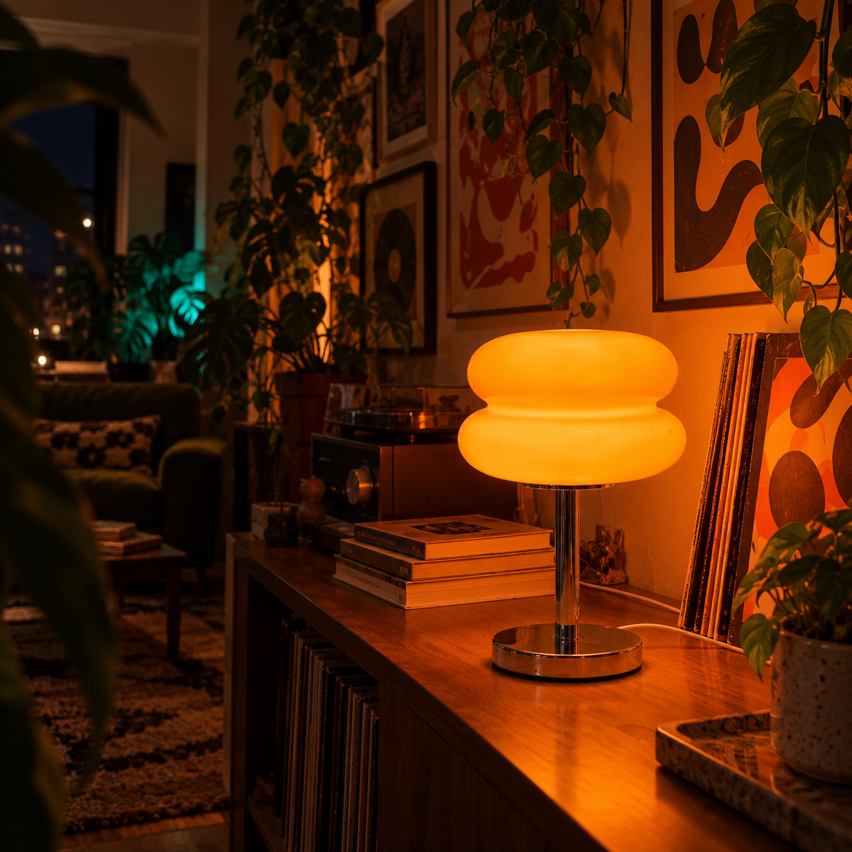 Orange Cumulus lamp glowing on a record console at night