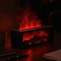 Black Ignis fireplace mist diffuser with red illuminated mist and a glowing ember bed in a dark room.