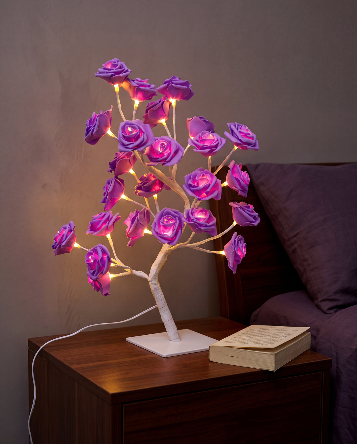 Purple Floreo rose tree lamp lit on a bedside table