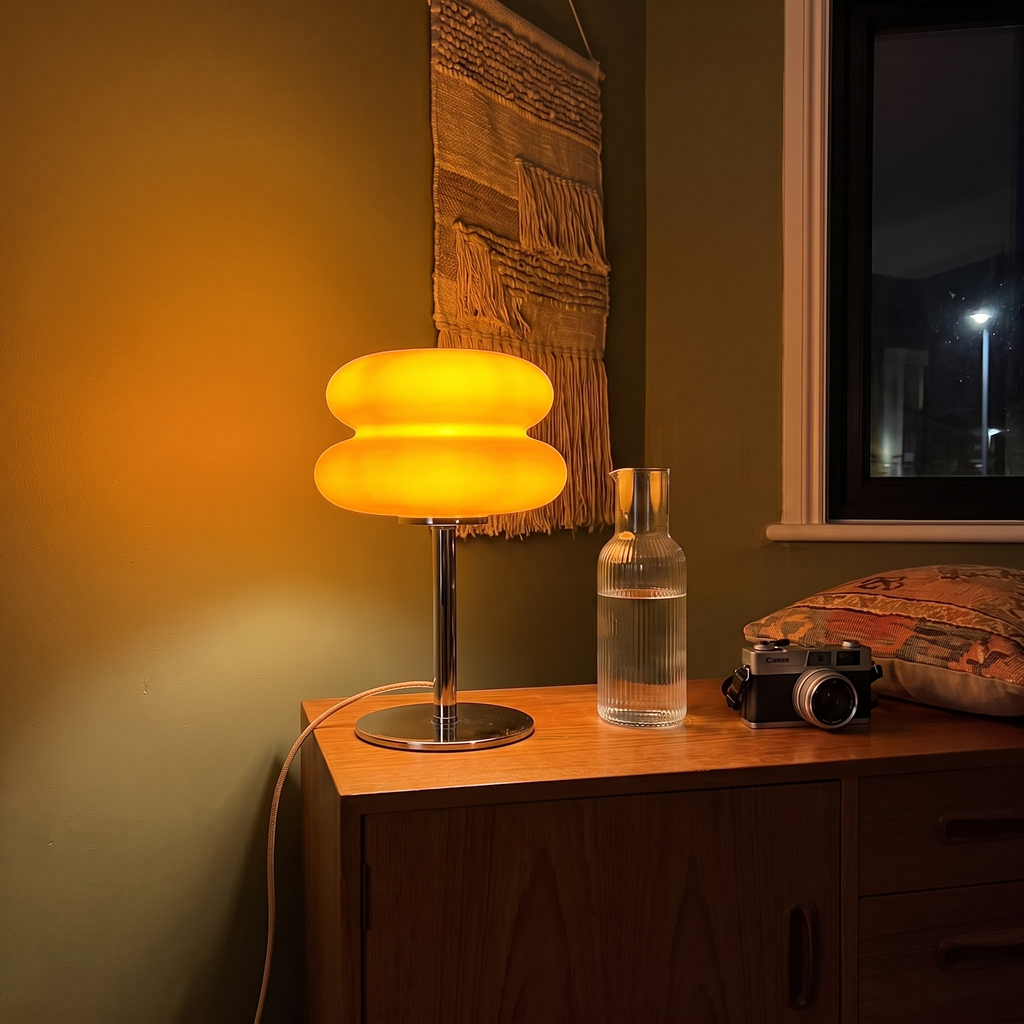 Orange Cumulus table lamp on a teak sideboard in a warm living room