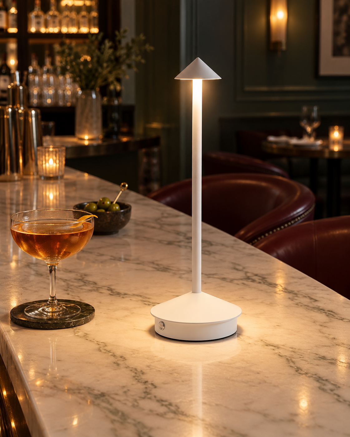 White Spire rechargeable table lamp on a marble restaurant bar